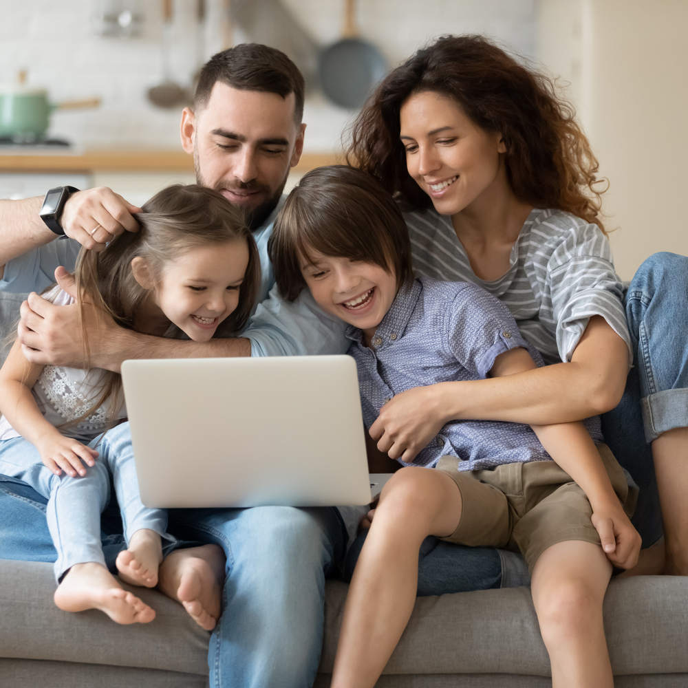 Family,With,Little,Kids,Spend,Time,Together,Seated,On,Couch